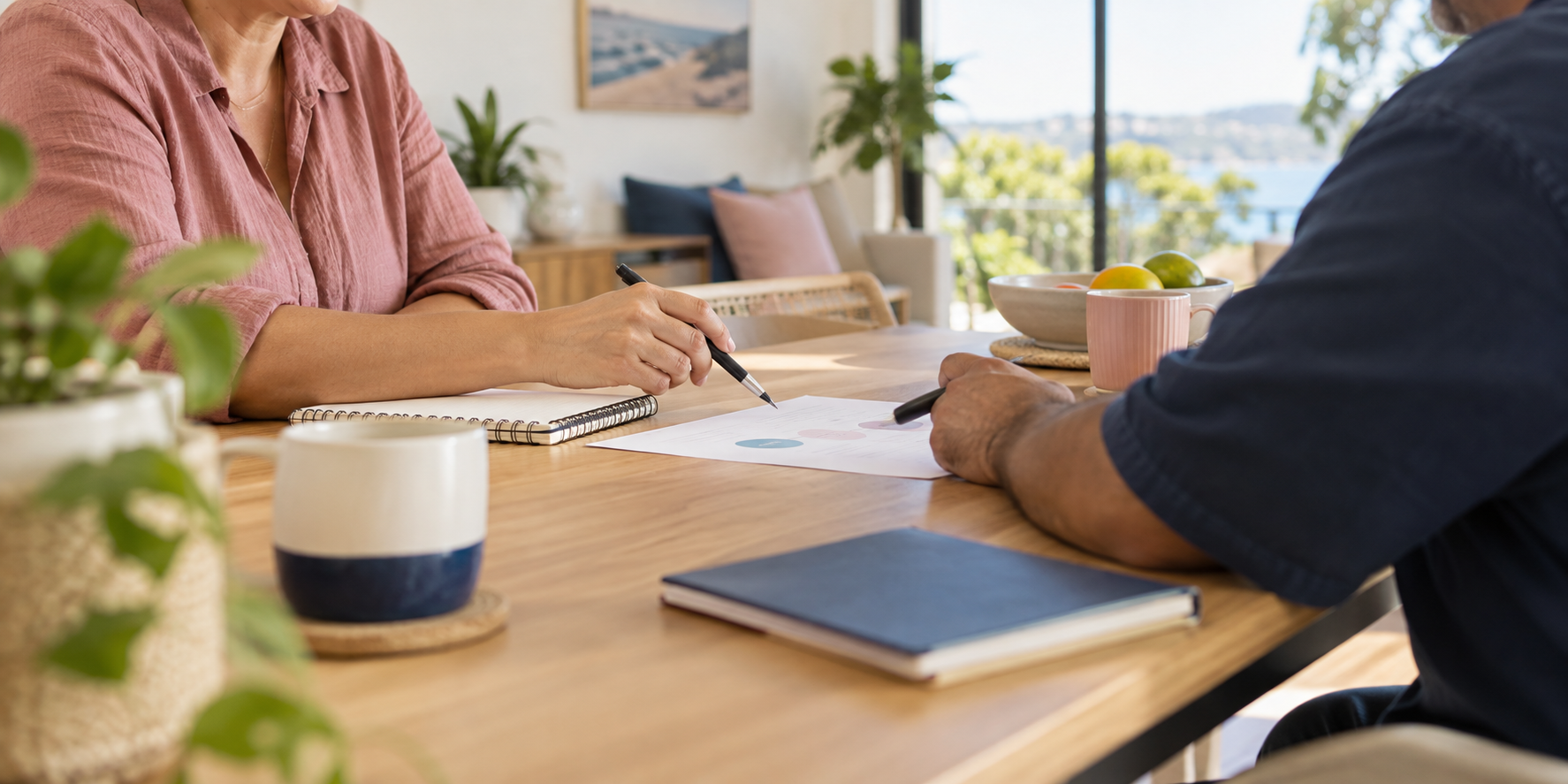 Two adults discussing goals and support options together at a table in a calm community setting.